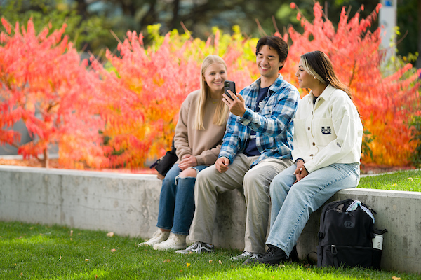 students sitting on a planter retainer