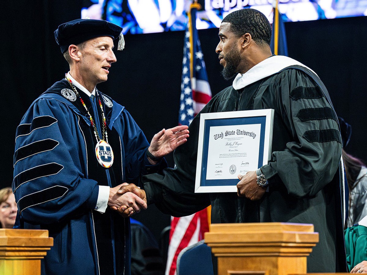Bobby Wagner receives a diploma from Brad Mortensen.