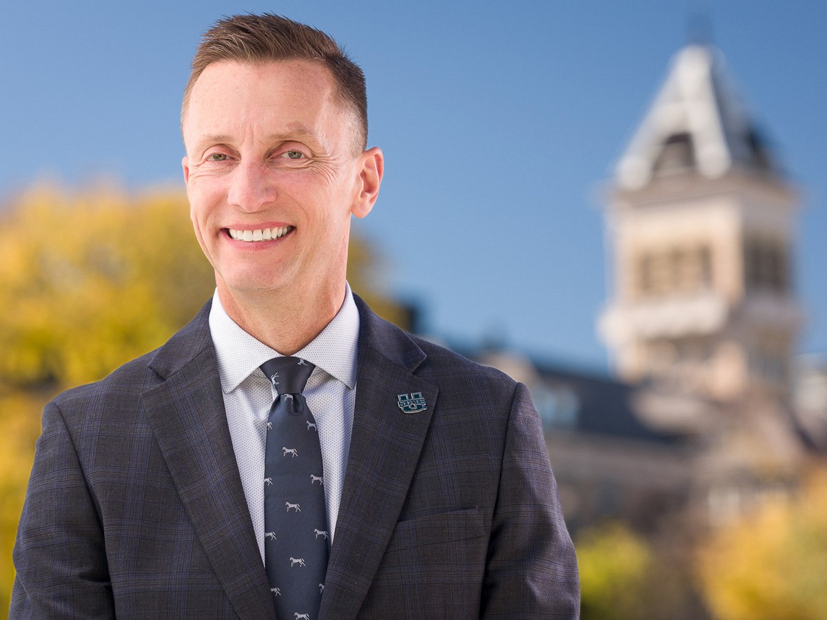 President Brad Mortensen outside USU's Old Main Building