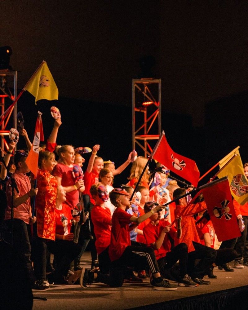 Aggies celebrate Chinese New Year in brightly-colored decor on stage in the Taggart Student Center.