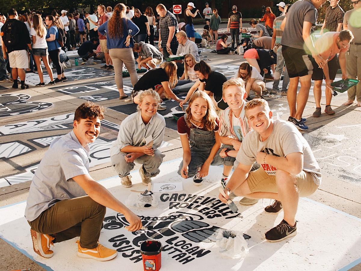 Students paint the TSC loop ground for Homecoming week