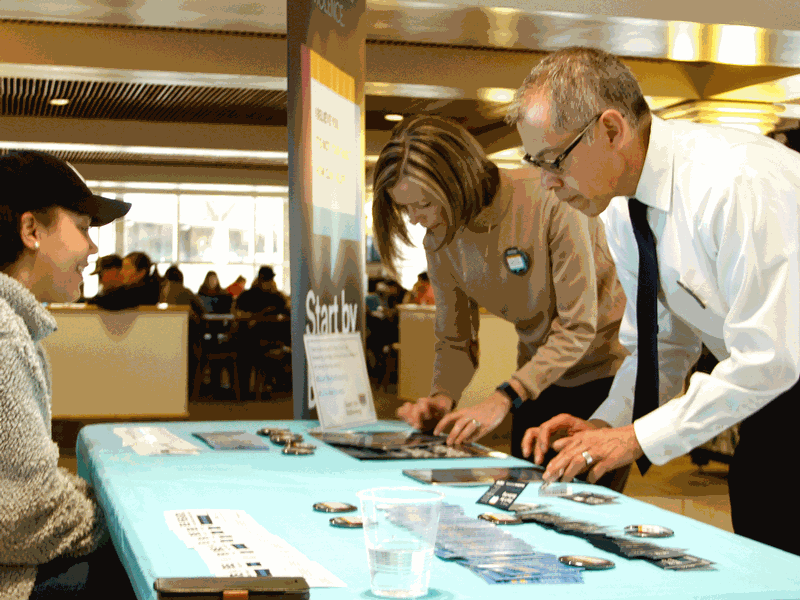 VP Morales and Suzann Thorpe signing a pledge at a booth in the Taggart Student Center.