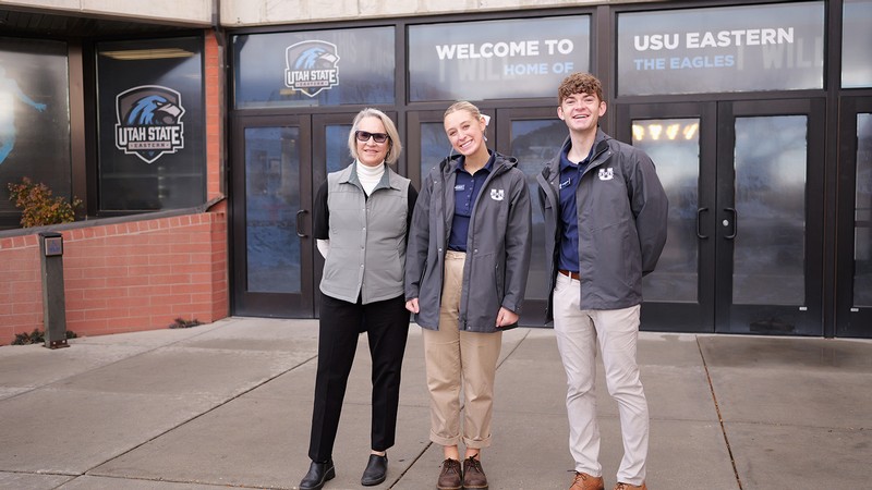 Three people pose for a photo