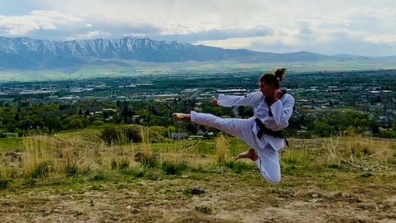 Student performs flying side kick.