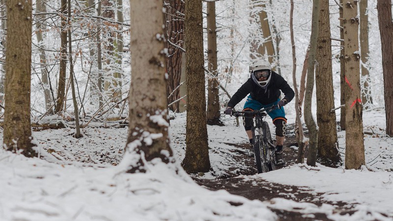 Person on a snow bike in the mountains.