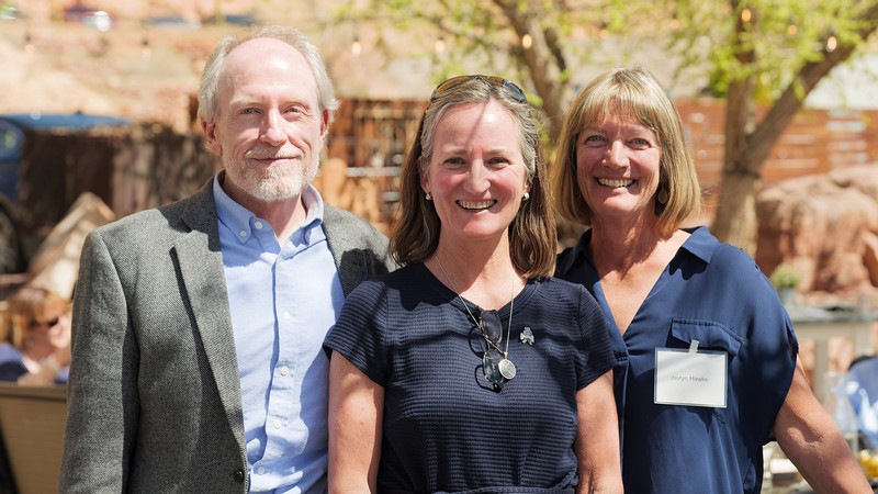 Three people pose for a photo.