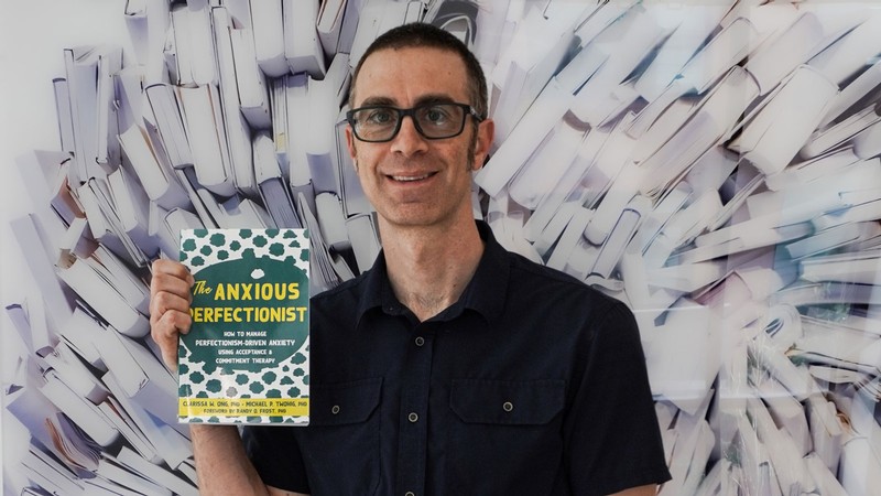 Mike Twohig holds a copy of "The Anxious Perfectionist."