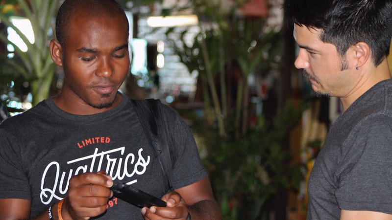 Researchers discuss a cell phone app in Brazil.