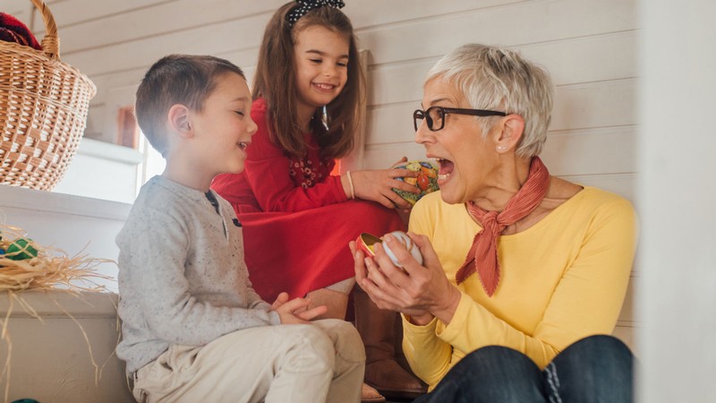 A person plays with two children.