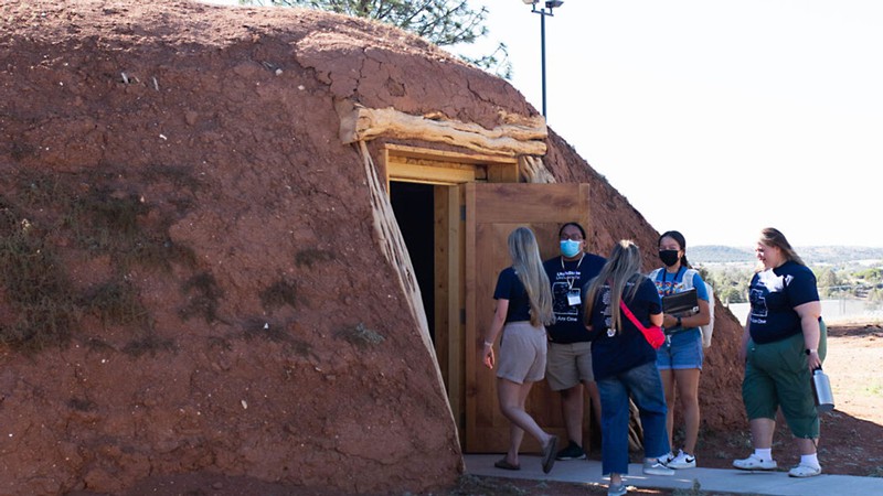 People touring a Hogan.