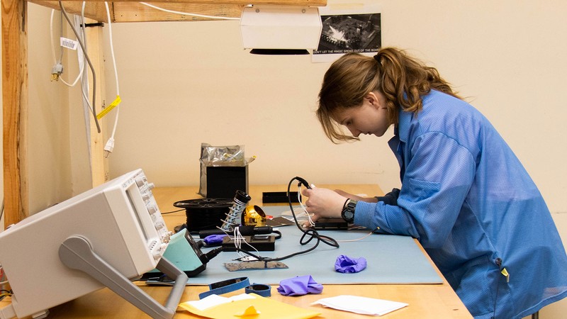 Donna Metcalf uses her soldering iron while working in the GAS lab on Feb. 27.