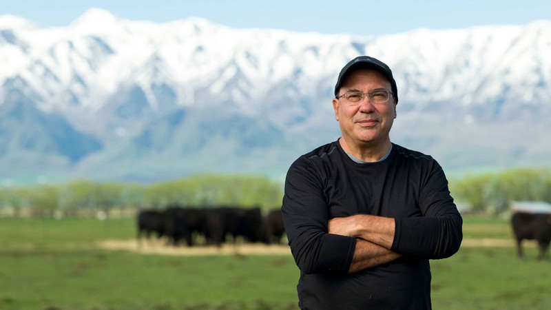 Juan Villalba poses for a portrait photograph in a Cache Valley cow pasture.