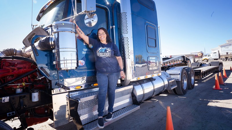 Angela Bloom standing on a semi cab.