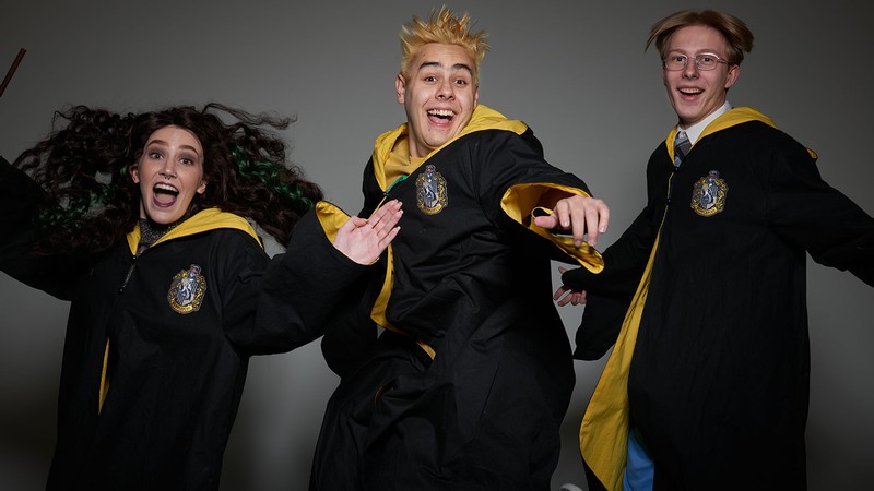 Three actors in wizard robes.