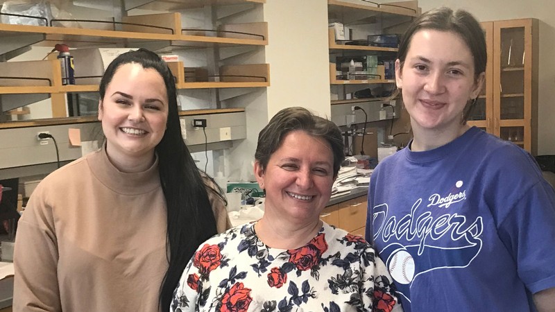 Three researchers standing in a lab.