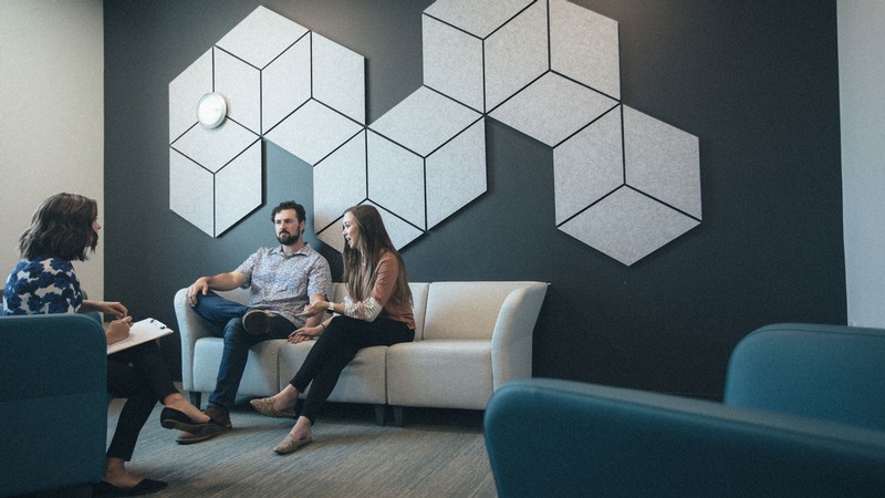 A therapist talks with clients.