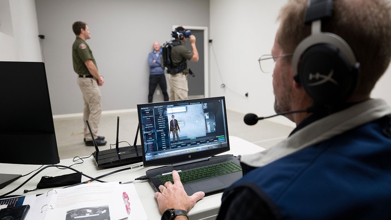 Police officers training with virtual reality equipment.