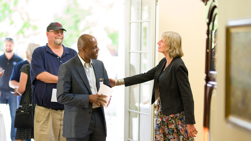 People greeting each other at an event.