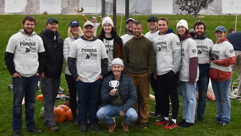 People wearing T-shirts that read "Pumpkin Toss."