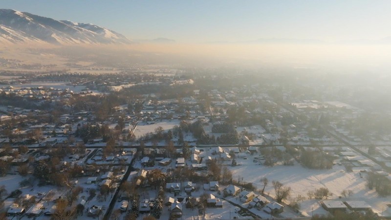 An aerial view of a smoggy town.
