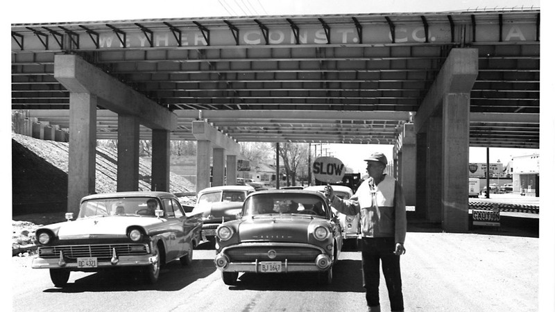 A worker stopping traffic in 1961.