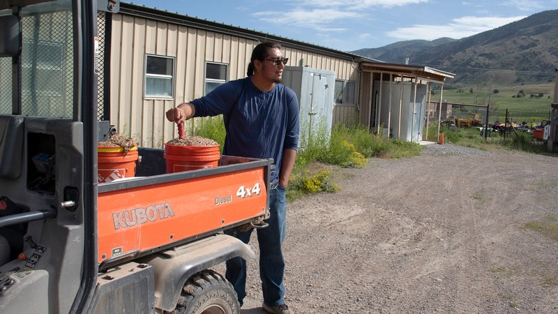 Tolonqua Nakai stands by a side-by-side utility vehicle.