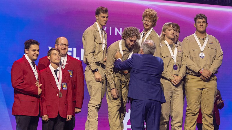 People receiving medals at an awards ceremony.