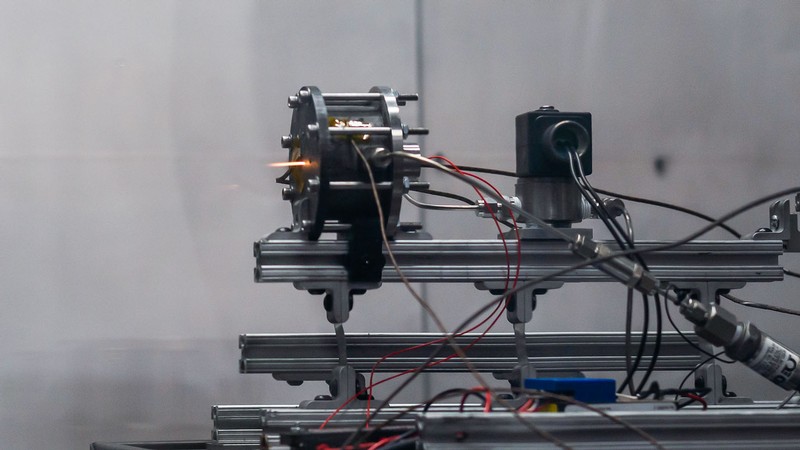 A satellite propulsion system test in a laboratory.