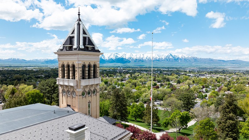 A drone shot of USU campus showing the landscape from a distance.
