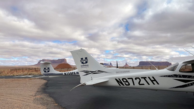 Two USU airplanes at an airstrip in the American southwest.