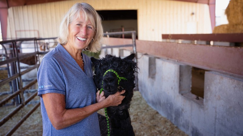 Noelle Cockett and an alpaca.