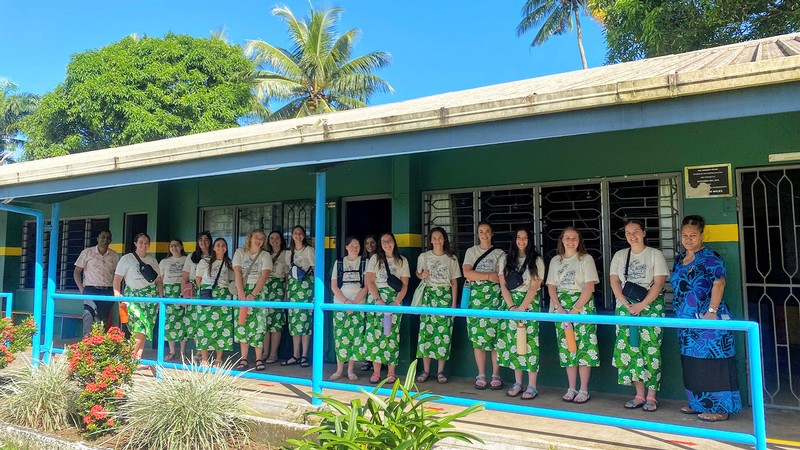 Educators outside a school in Fiji.