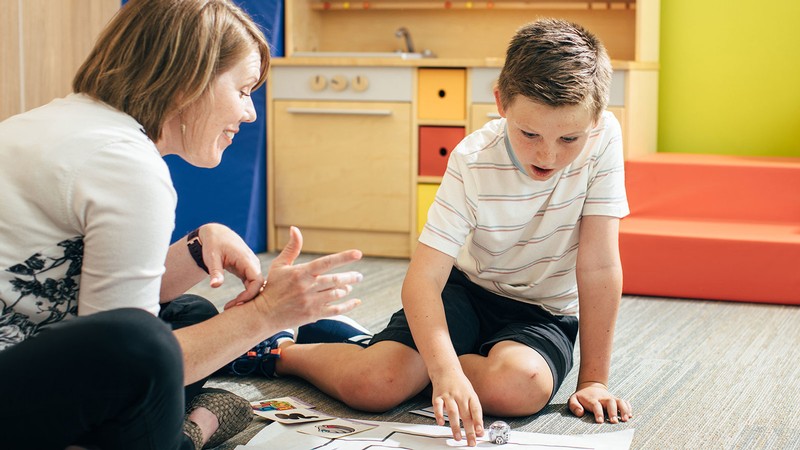 A teacher speaking to a student.