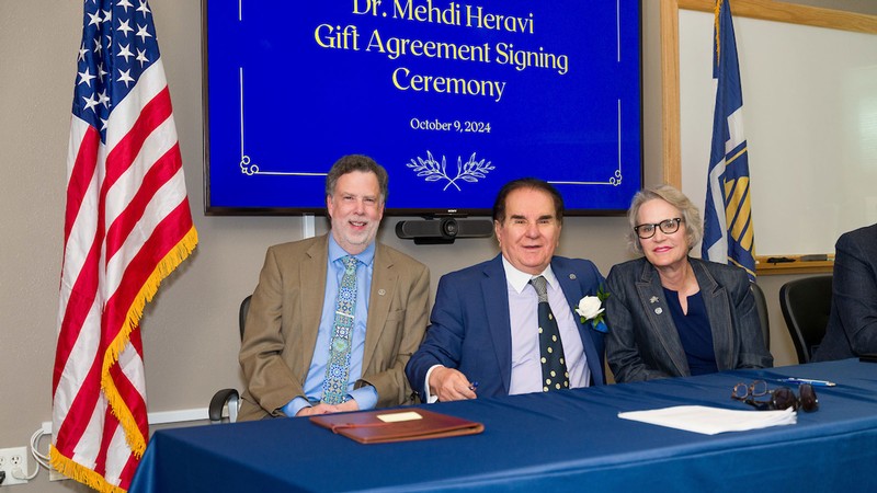 Joseph Ward, Medhi Heravi and Elizabeth Cantwell at a ceremony.