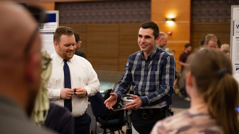 People talking at an event.
