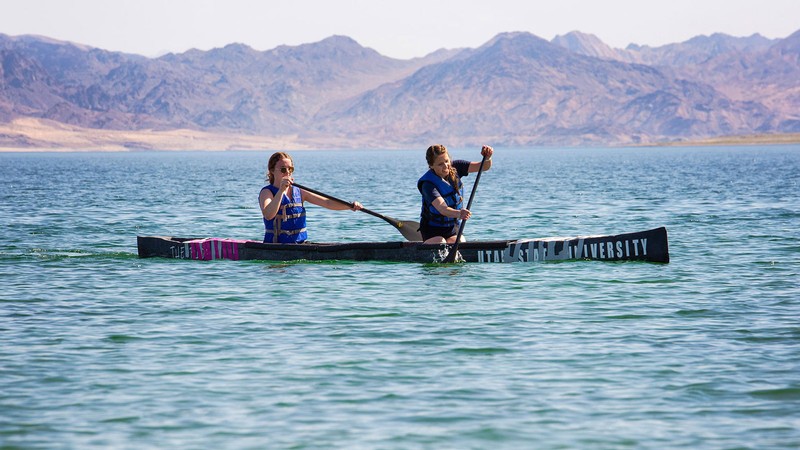 Student paddling a concrete canoe.
