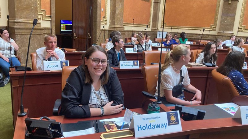 Students seated at legislators' desks at the Utah Capitol.