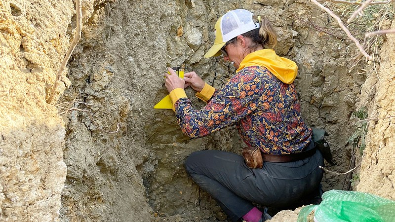 A geoscientist measuring an earthquake rupture.