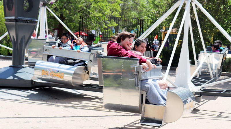 Teens on an amusement park ride.