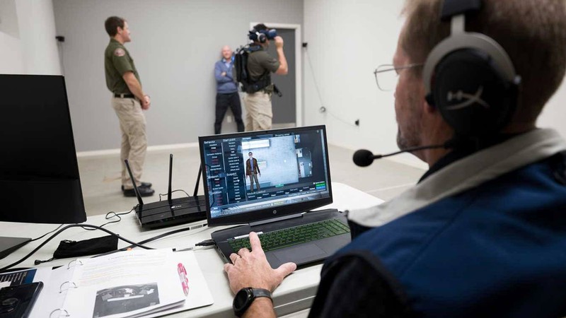 People using virtual reality equipment to train police officers.
