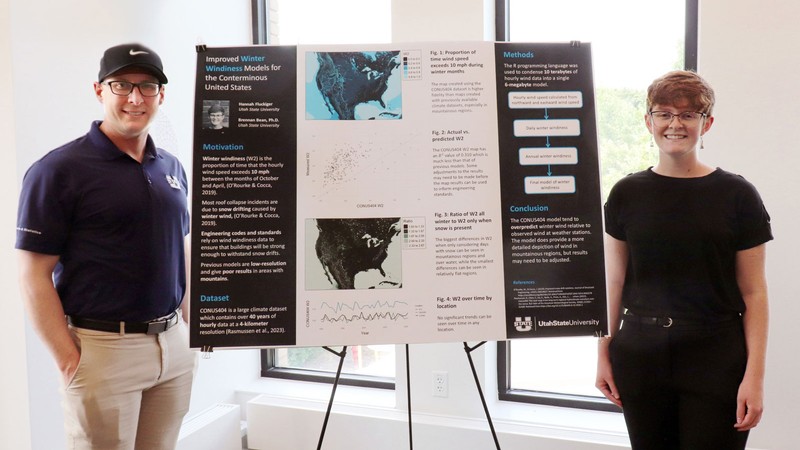 Brennan Bean and Hannah Fluckiger posing with a research poster.