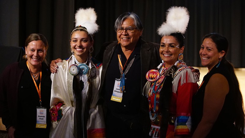 People wearing professional and traditional Native American attire.