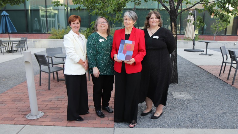 People standing with an award.