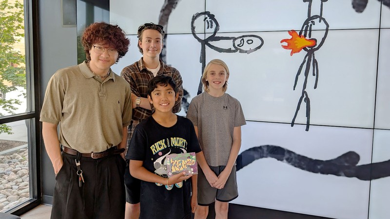 People posing with art projects.