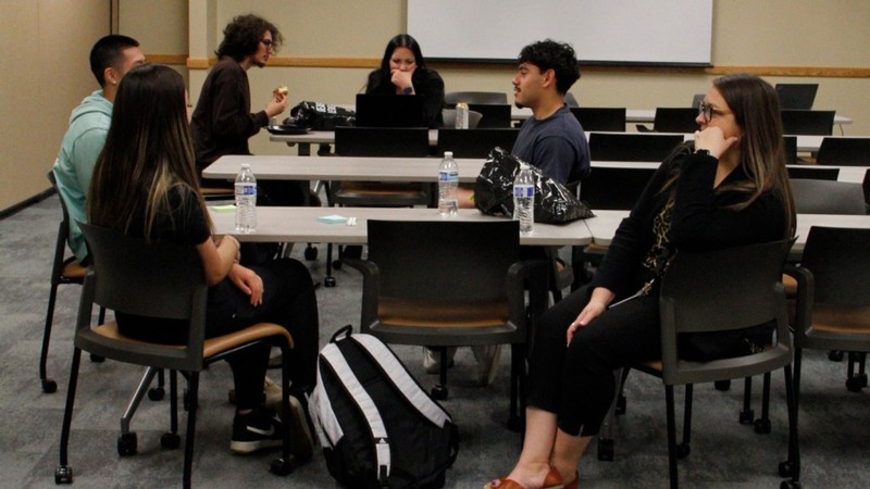 People speaking in a classroom.