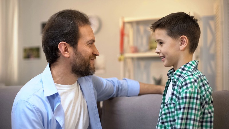 A parent and a child looking at each other.