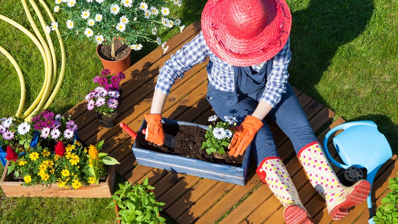 A person working with flowers outdoors.