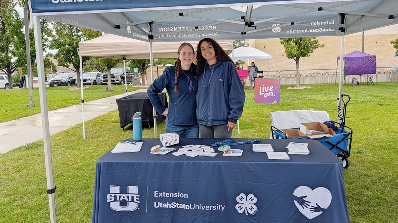 Ashley Yaugher and Candace Johnnie in an information booth.