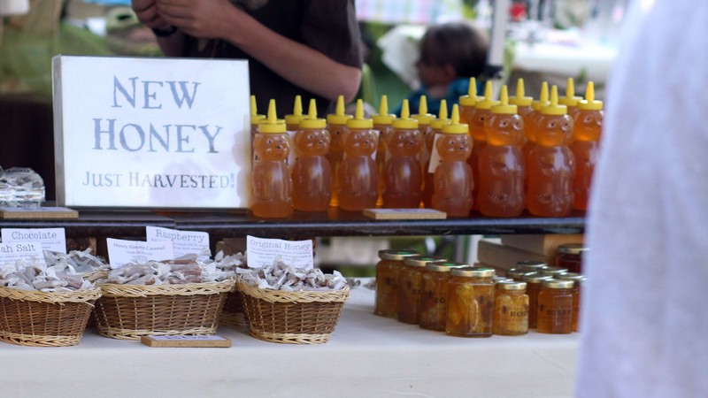 Bear-shaped bottles of honey at a farmer's market.
