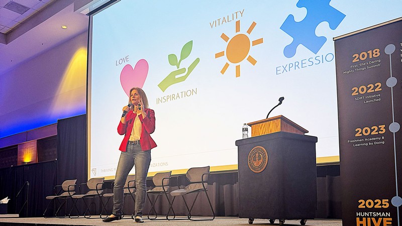 Erin Clark speaking on a stage.